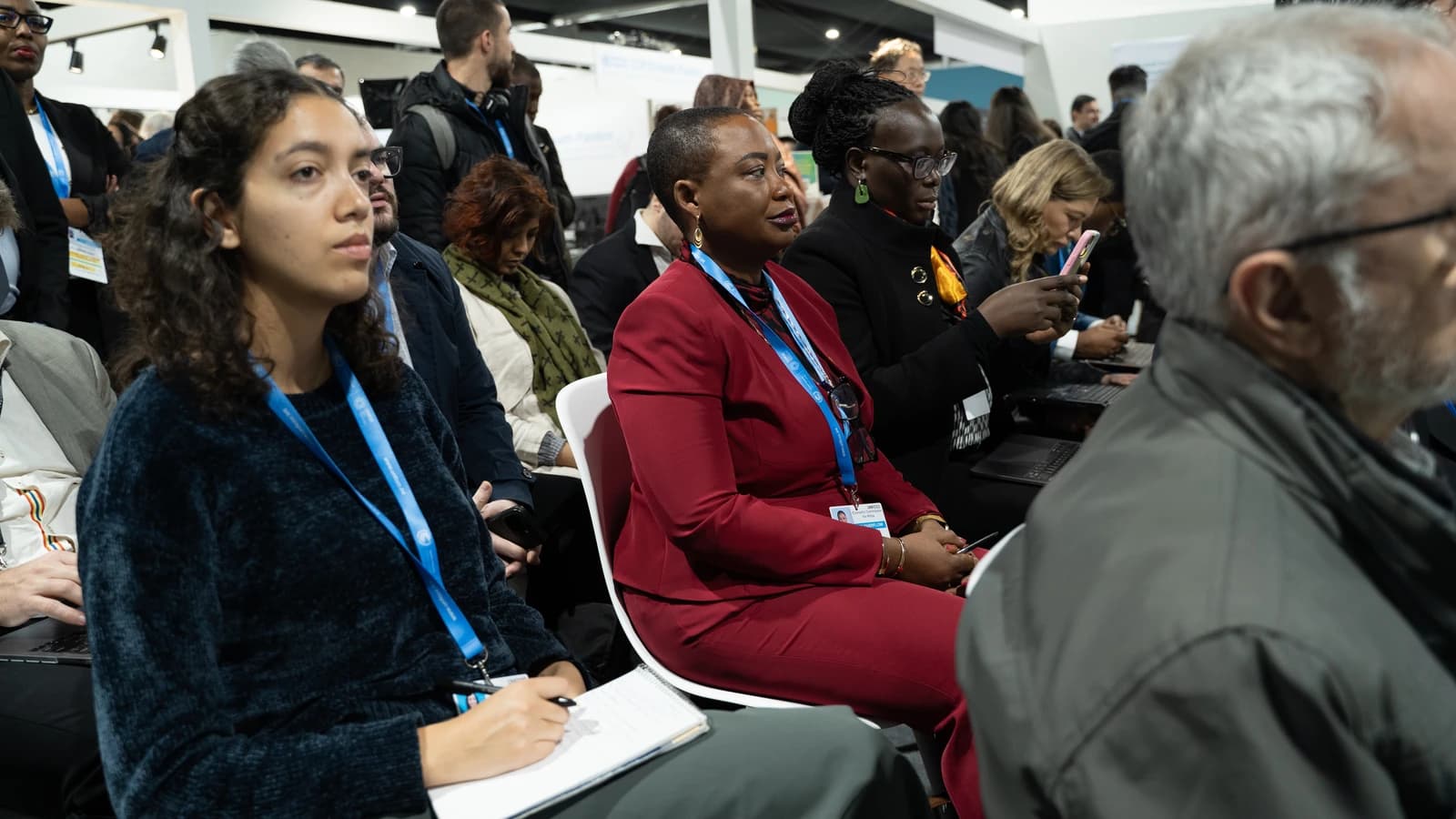People listening intently in a conference setting at UNCTAD COP29 event.