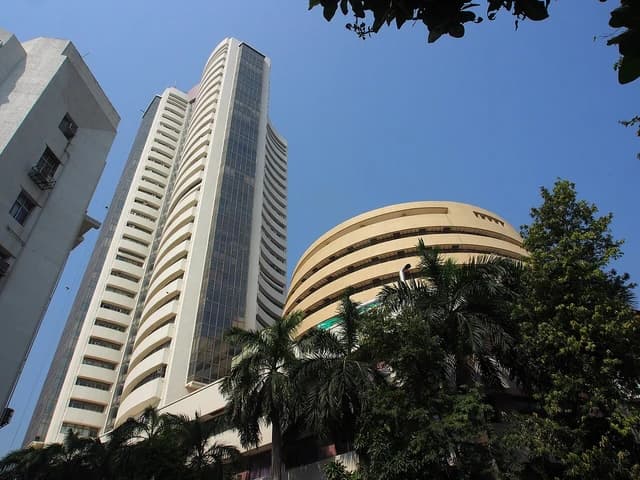 Side view of the Bombay Stock Exchange (BSE) building against a clear blue sky.