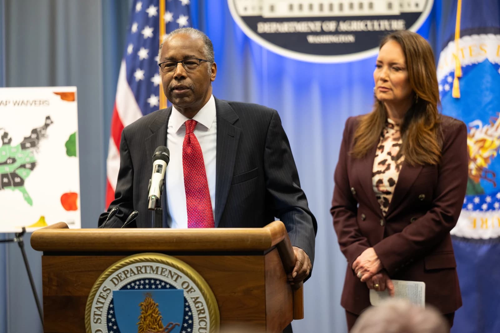 Dr. Ben Carson speaks at a podium with a microphone at the Department of Agriculture.