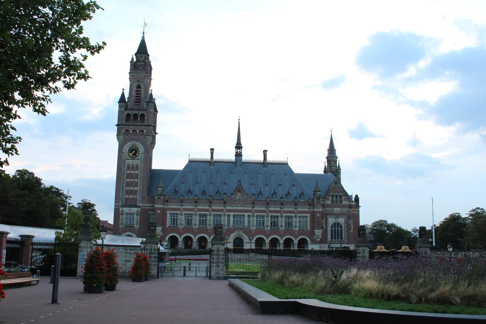 The Peace Palace building in The Hague, Netherlands, under a cloudy sky.