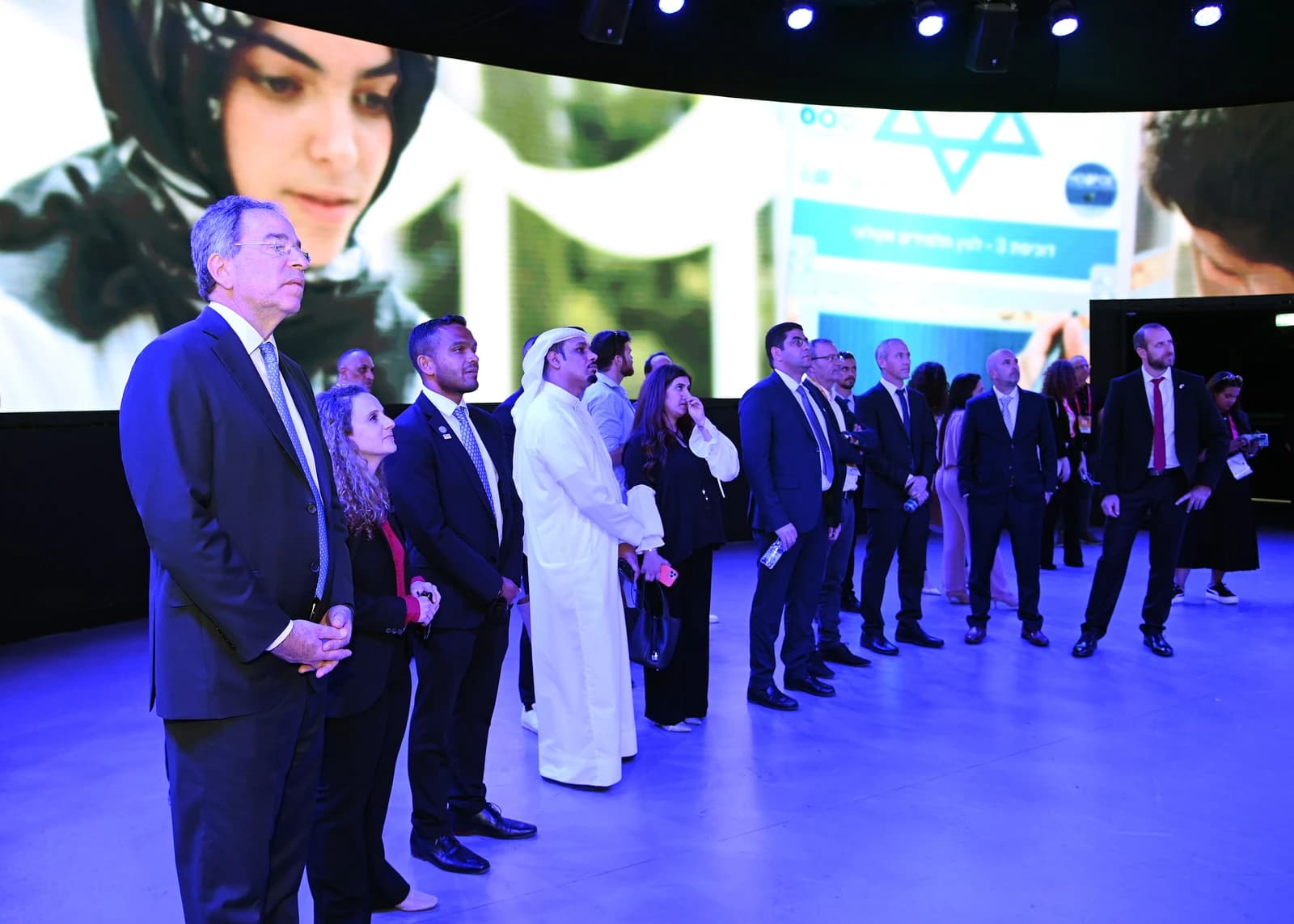 US Ambassador to the UAE, standing with others at an event.