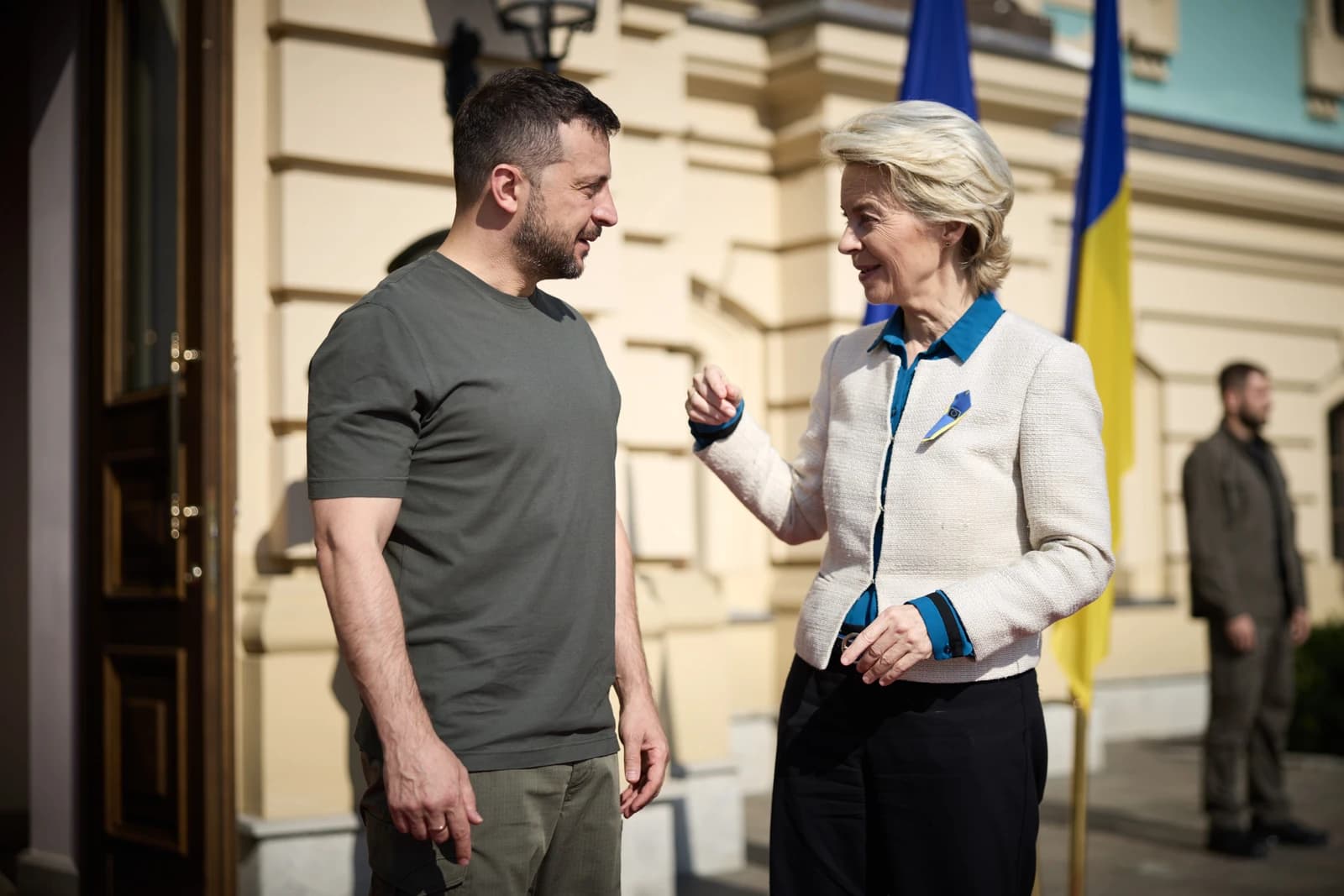 Ukrainian President Volodymyr Zelenskyy speaking with EU Commission President Ursula von der Leyen outdoors.