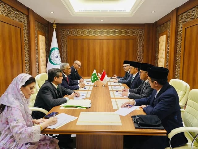 Ishaq Dar, Pakistan's Foreign Minister, sitting at a conference table with other officials.