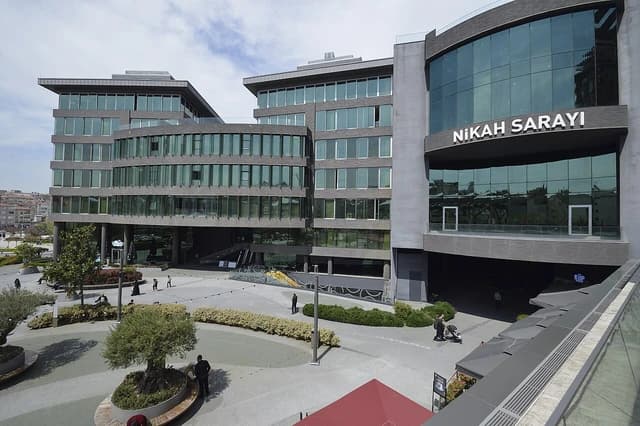 Exterior of the modern Istanbul Nikah Sarayı building with glass facade and stone details.