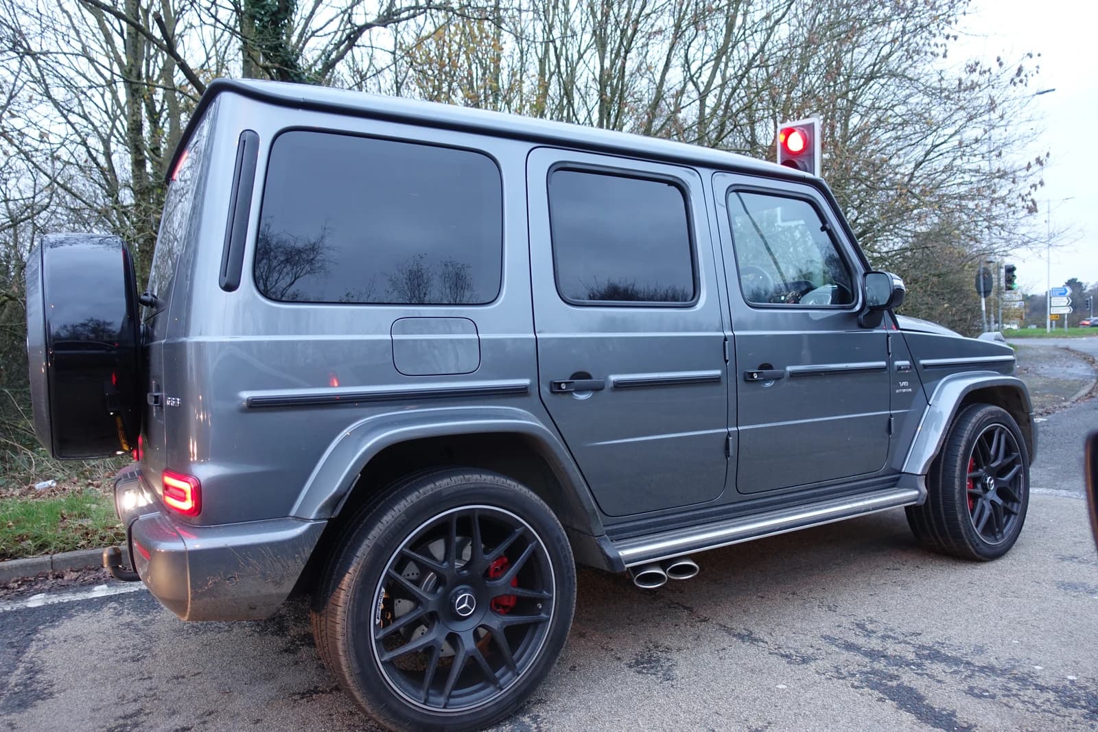 Grey Mercedes-Benz G63 AMG V8 BITURBO SUV parked on a paved surface.