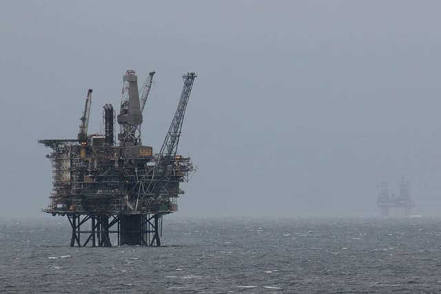 An offshore oil and gas platform, Gyda Block 2/1, in the middle of a choppy sea.