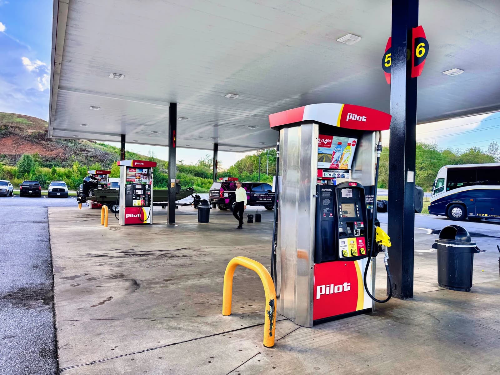 Fuel pumps at a Pilot Flying J gas station with vehicles in the background.