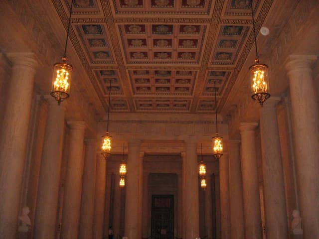 The ornate ceiling and illuminated chandeliers of the Great Hall inside the Supreme Court Building.