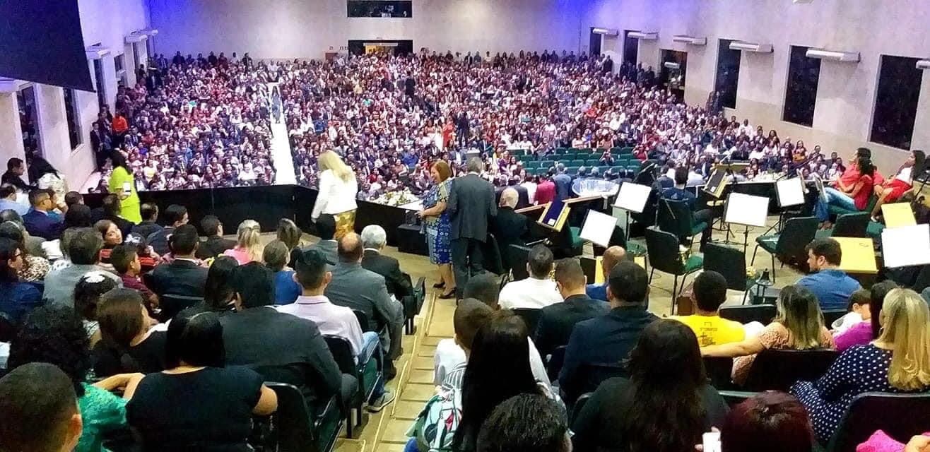 People gathered inside a large church or auditorium for a religious service.
