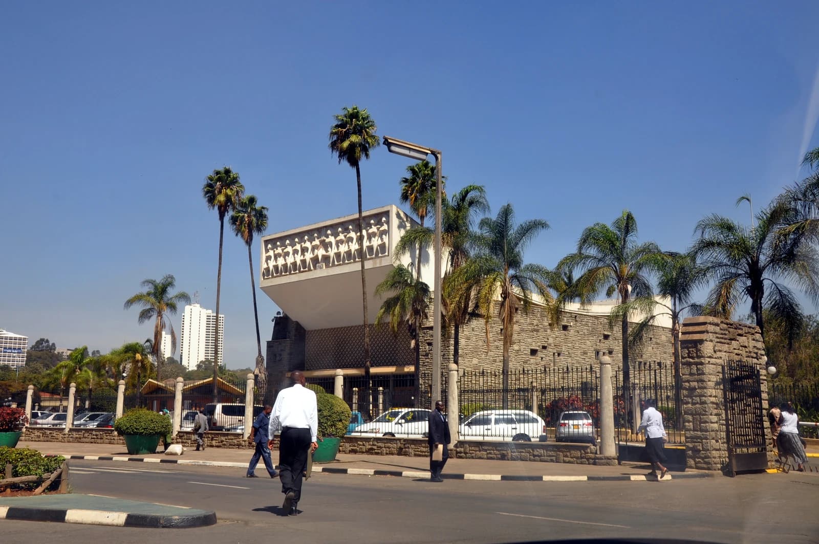People walk on a street near the Parliament Buildings in Nairobi, Kenya.