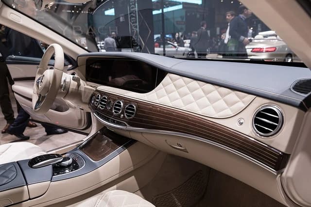 Interior of a Mercedes-Maybach S 650 showing dashboard, steering wheel, and luxurious finishes.