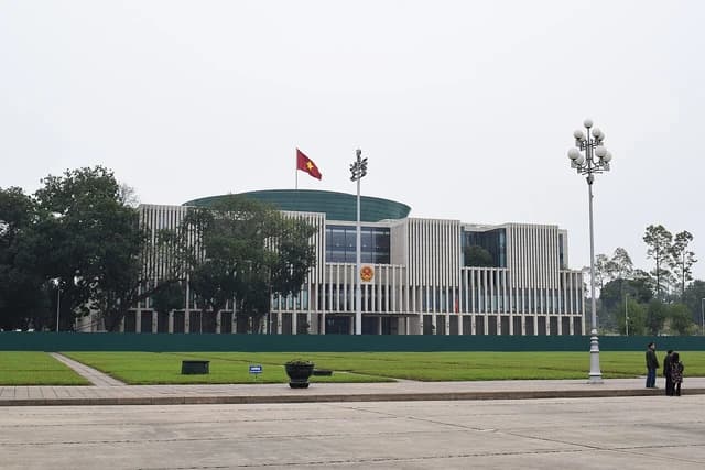 Exterior view of the Vietnam Parliament building, a modern structure with vertical facades.