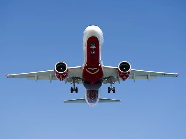 AnimaWings aircraft, registration YR-FUN, flying through a clear blue sky.