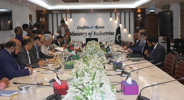 Jam Kamal Khan, Pakistan Commerce Minister, sits at a conference table with Adilur Rahman Khan.