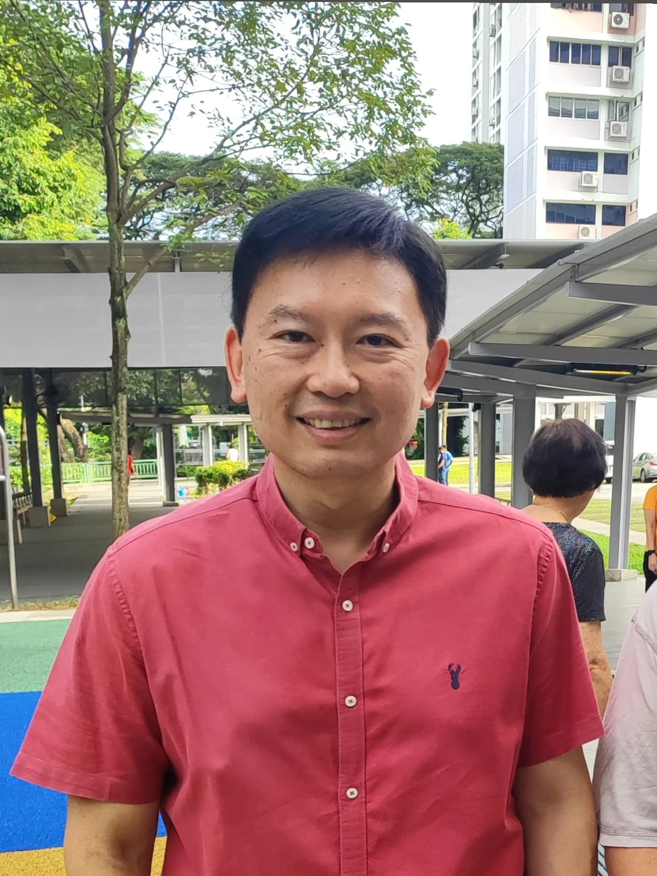 Chee Hong Tat, Singapore's Minister of State for Trade and Industry, smiling outdoors.