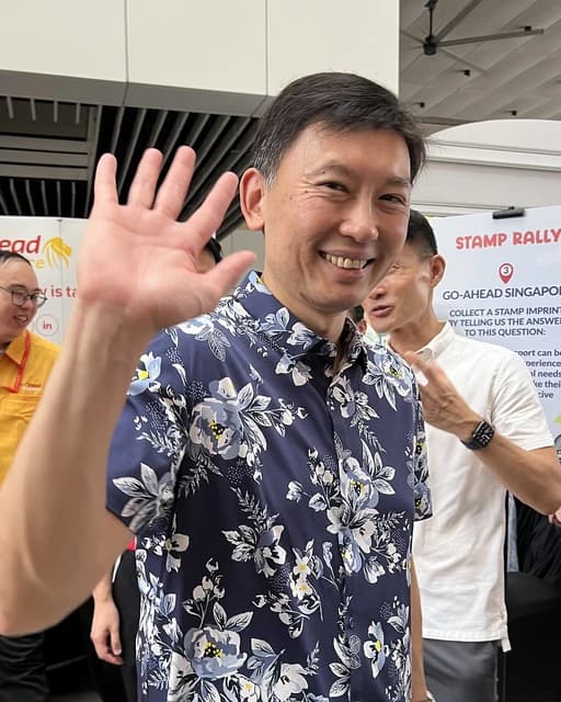 Chee Hong Tat, Acting Minister for Transport, smiling and waving to the camera.