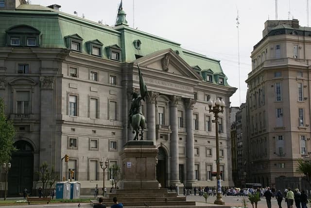 Exterior of the Banco de la Nación Argentina building in Buenos Aires, with a statue in the foreground.