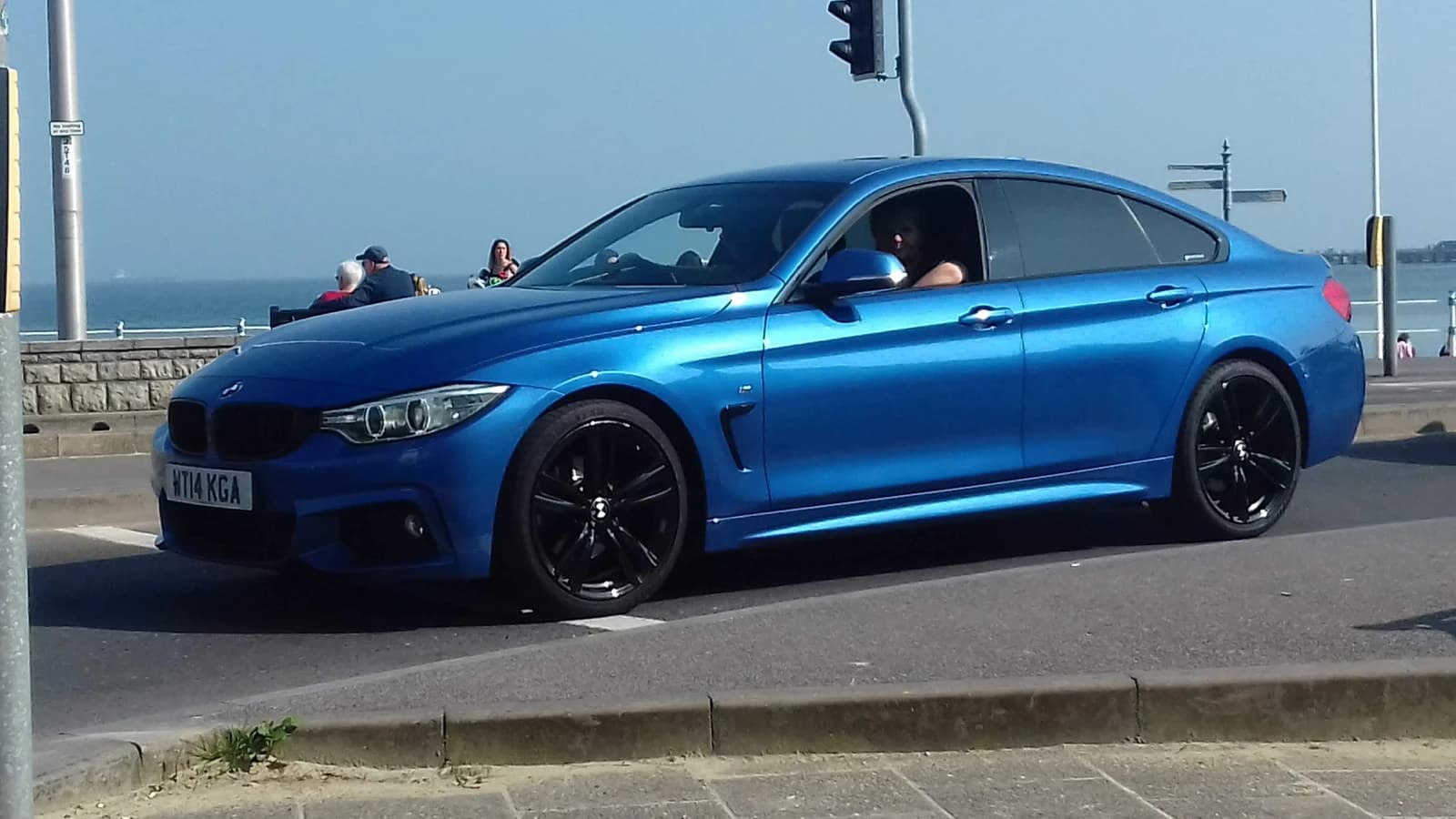 Blue 2014 BMW 420D Gran Coupe M Sport Auto driving on a sunny day.