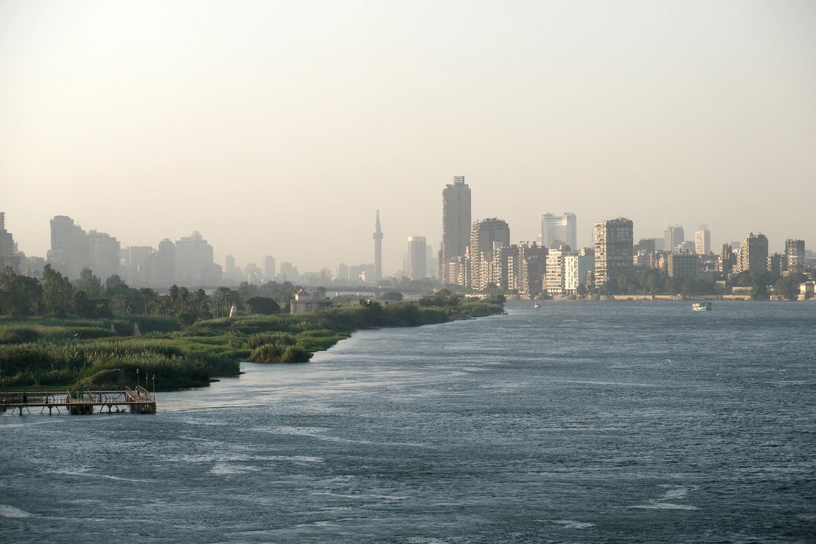 Panoramic view of the modern Cairo skyline with buildings along the Nile River.