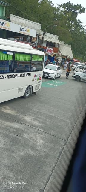 White Changan Alsvin taxi with other vehicles on a street in Baguio City.