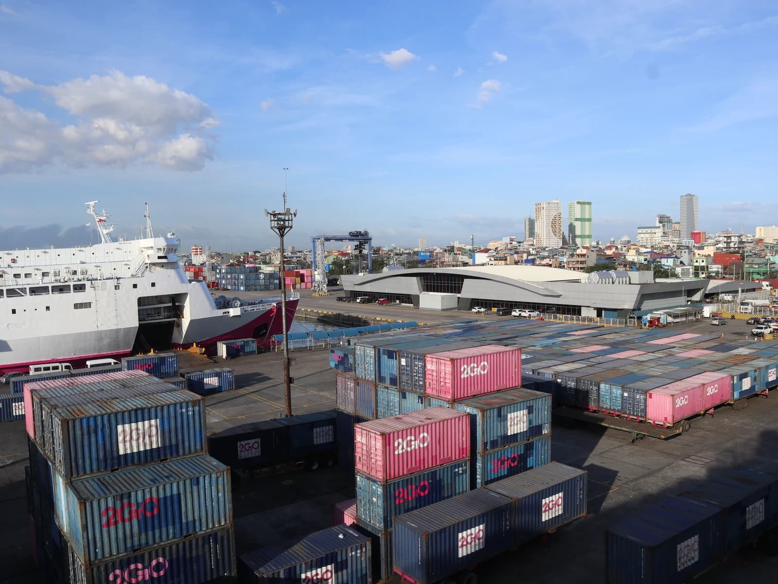 Cargo containers, a ship, and buildings at Manila North Harbor Pier 4.