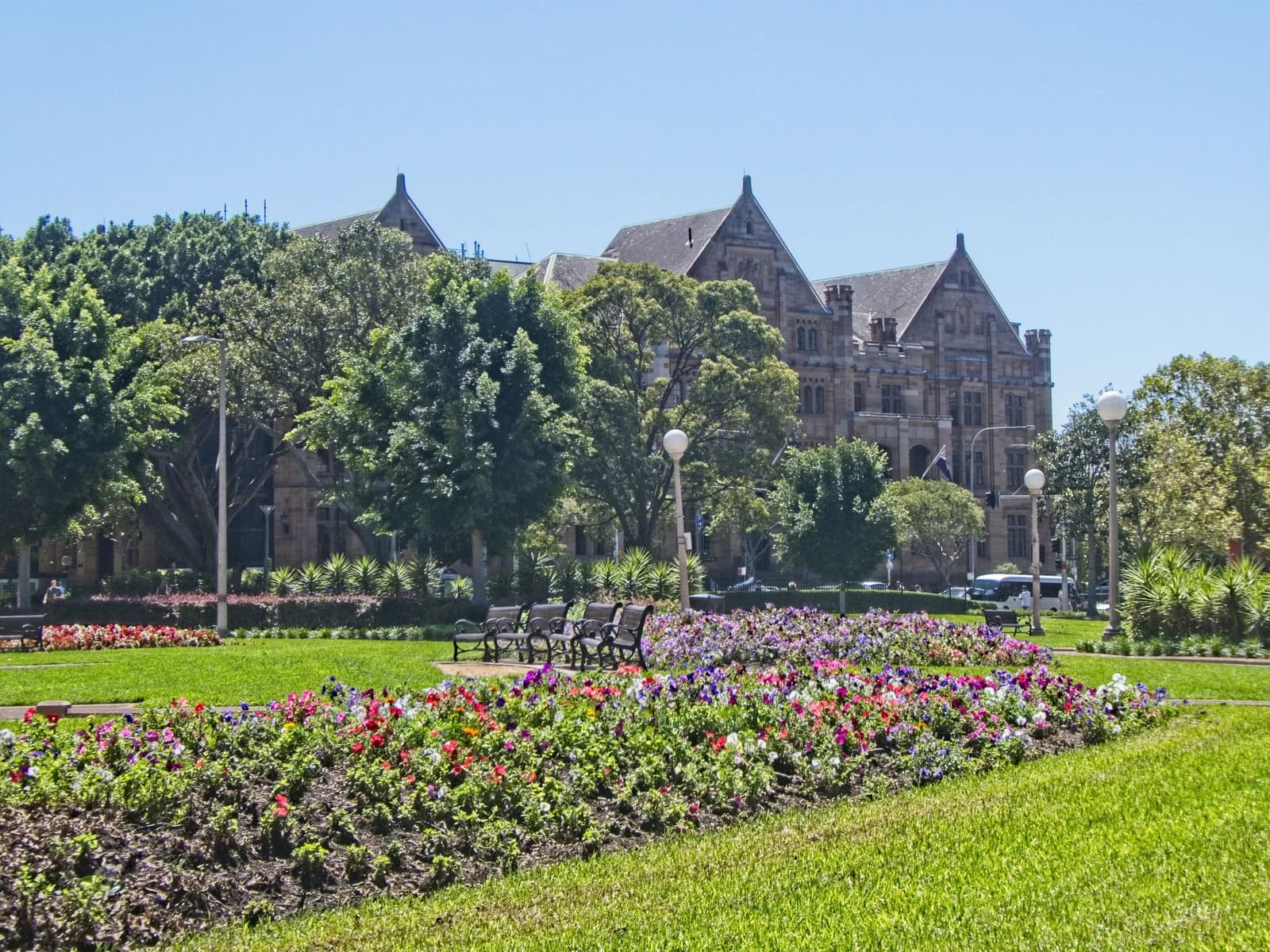 Registrar-General's building (Land Titles Office) facade visible behind trees and a park.
