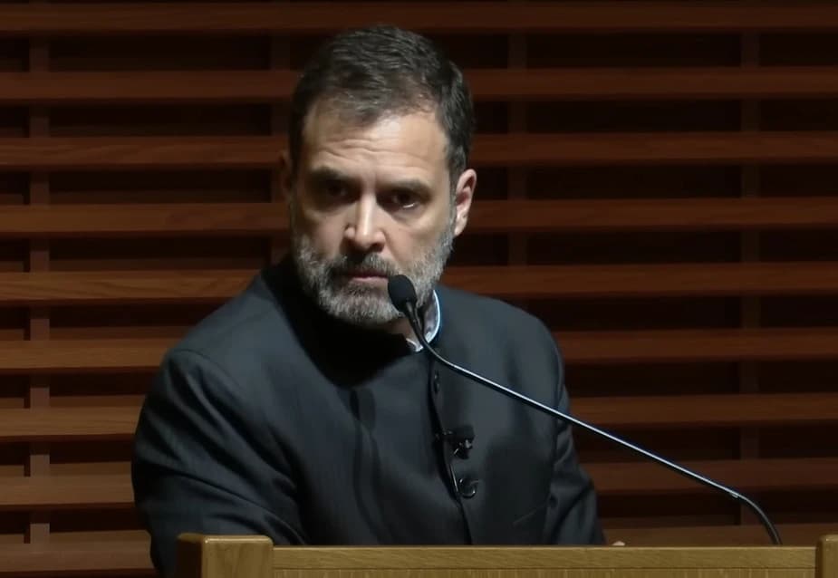 Rahul Gandhi, Indian politician, speaking at a podium with a microphone.