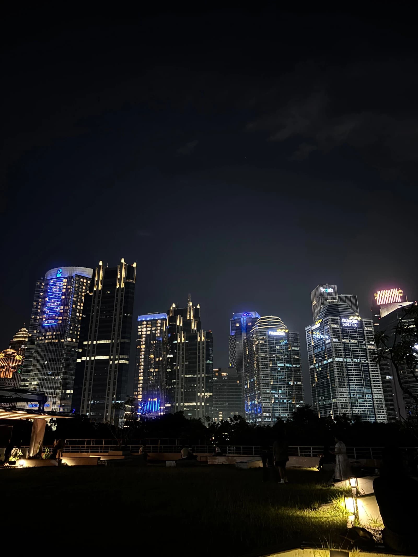 Skyscrapers brightly lit at night in the Mega Kuningan district of Jakarta.