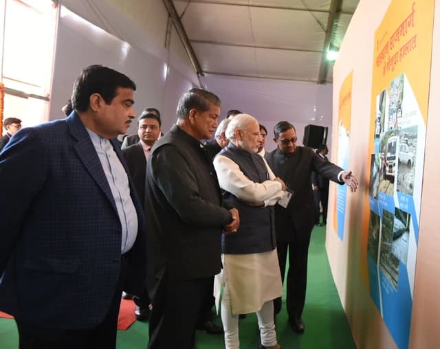 Prime Minister Narendra Modi visits an exhibition in Dehradun, Uttarakhand, with other officials.