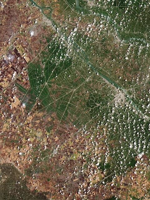 Satellite view of the Mekong Delta, showing vast agricultural landscapes and rivers.