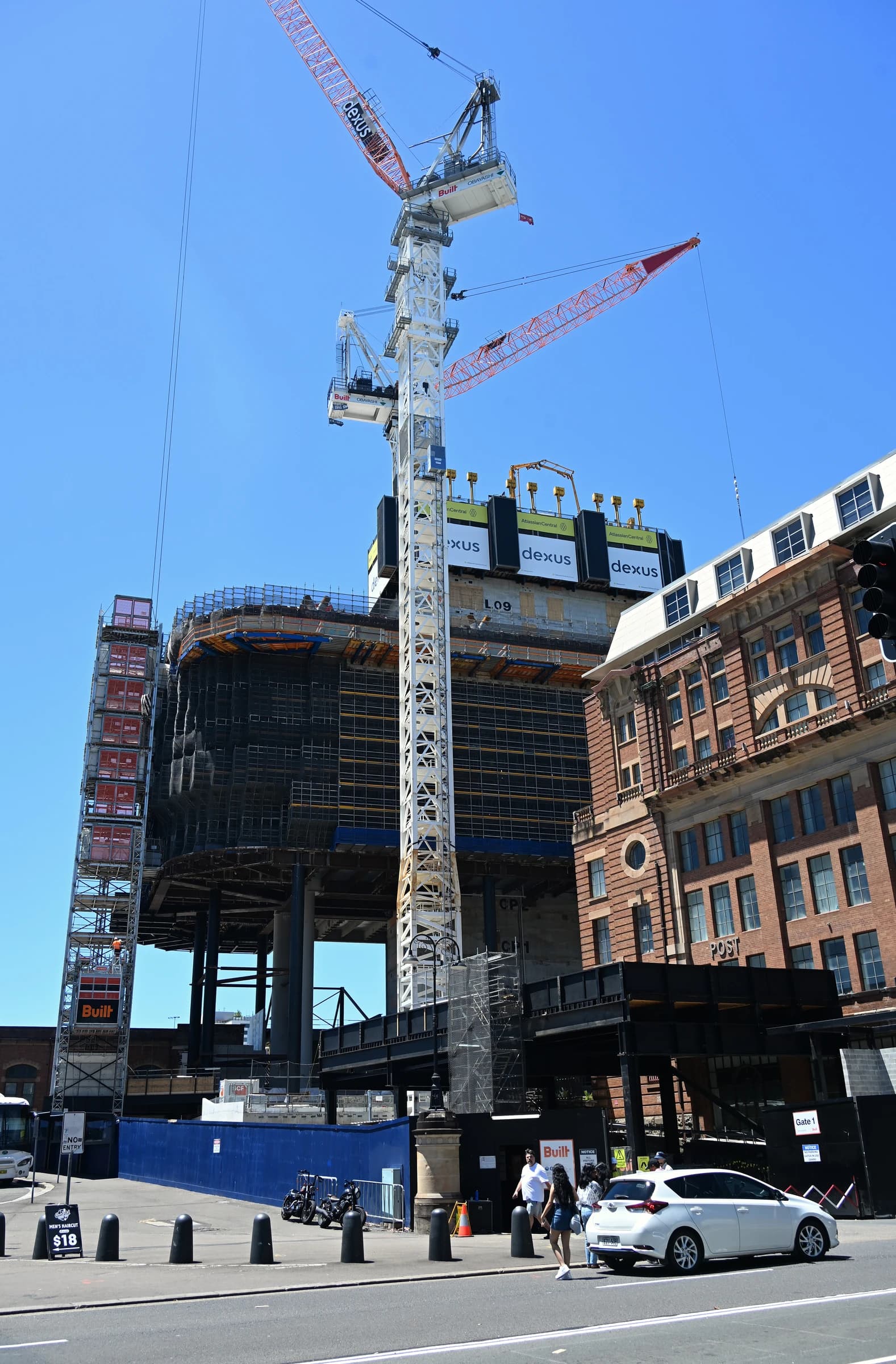 Atlassian Central building under construction with cranes and scaffolding in urban setting.