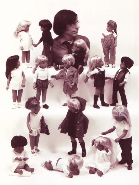 Bruce Duhan, doll designer, posing with multiple Sasha Dolls for a catalog.