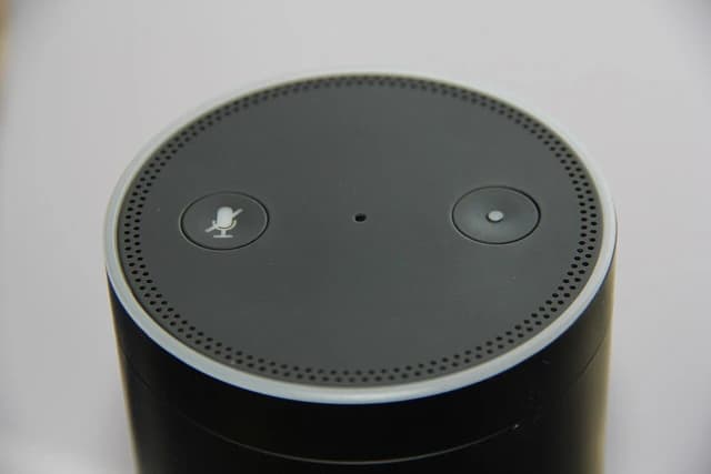 Top view of a black Amazon Echo Plus speaker with microphone and action buttons.