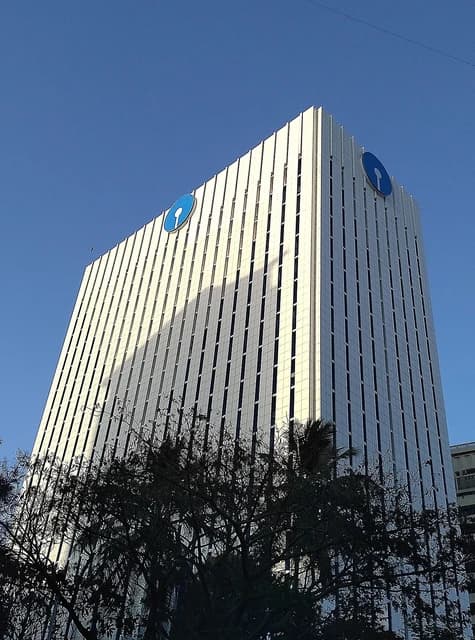 State Bank of India headquarters building in Mumbai, viewed from an angle against blue sky.