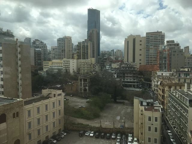 City skyline of Beirut, Lebanon, with a mix of modern and older buildings.