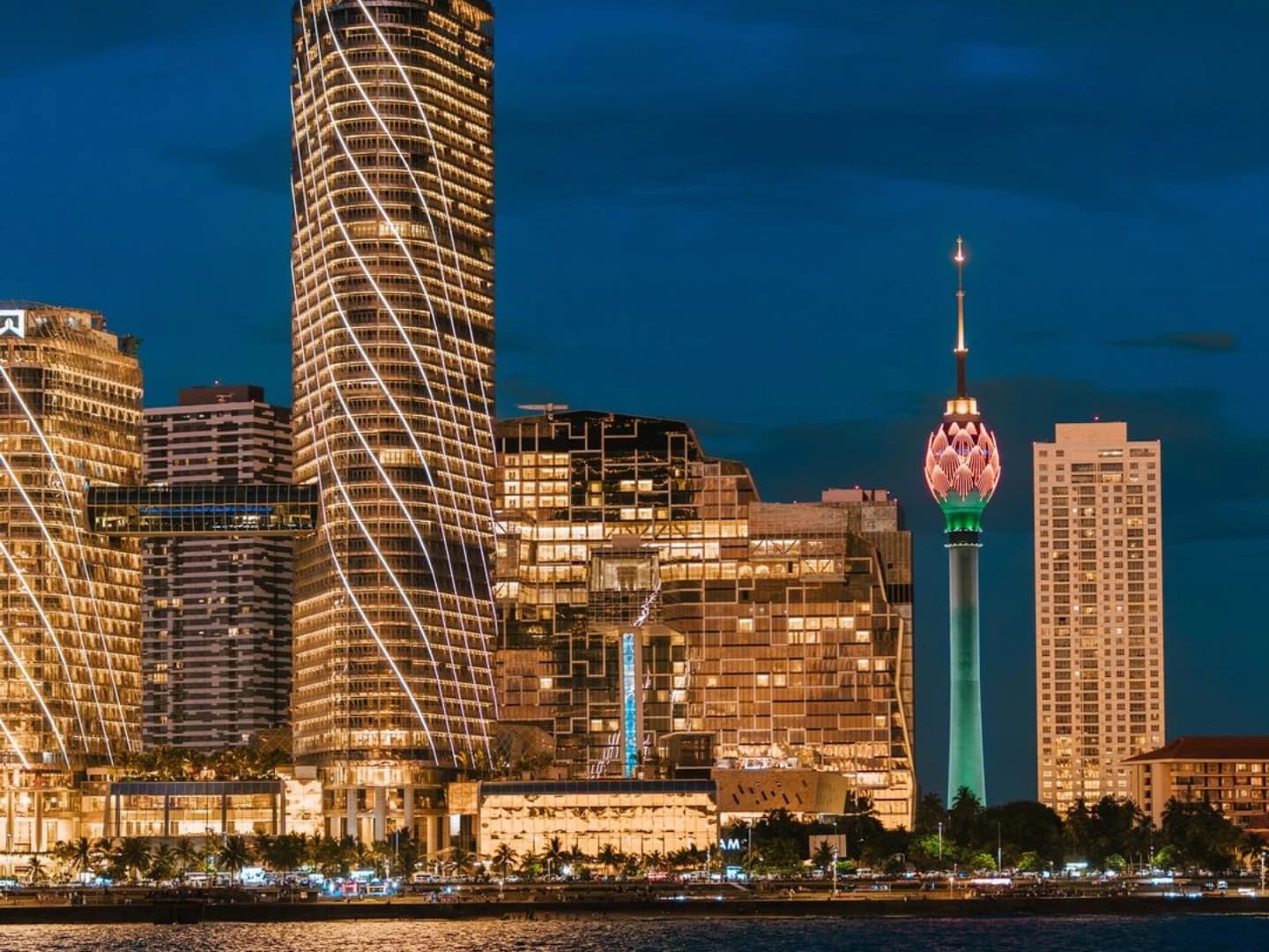 Colombo city skyline at night featuring illuminated buildings and the Lotus Tower.
