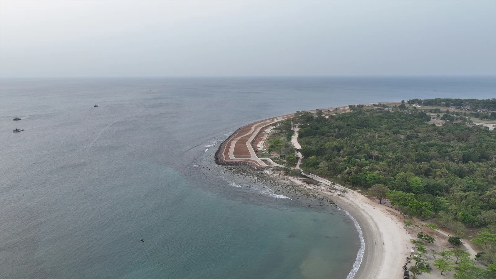 Aerial view of Tanjung Lesung Special Economic Zone coastline with sea and trees.