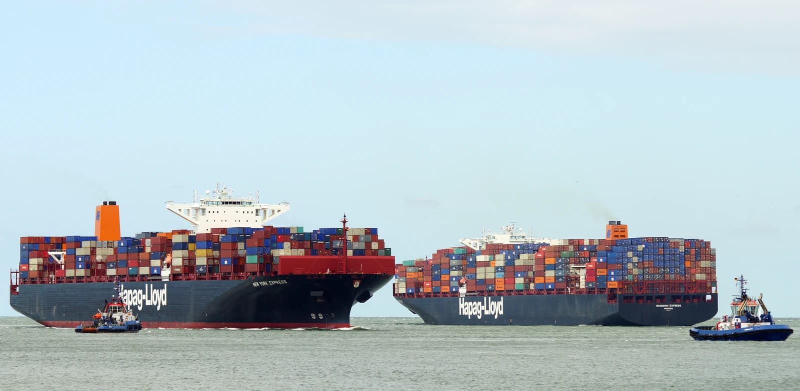 Two large Hapag-Lloyd container ships, 'New York Express' and 'Shanghai Express', at sea.