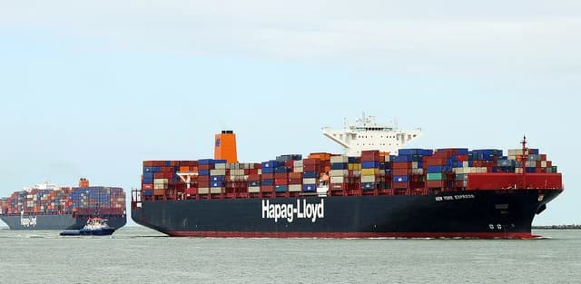 The container ship New York Express sailing with many cargo containers on board.
