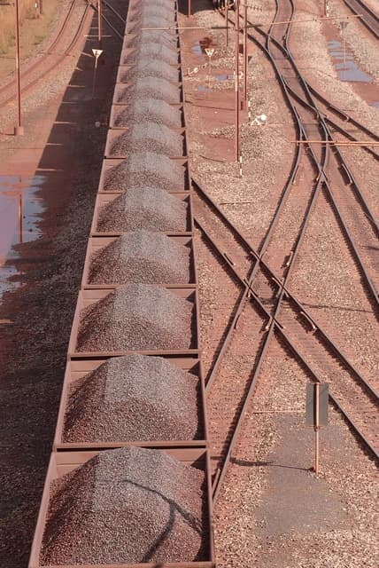 Train cars filled with iron ore on tracks at Sishen Mine in South Africa.