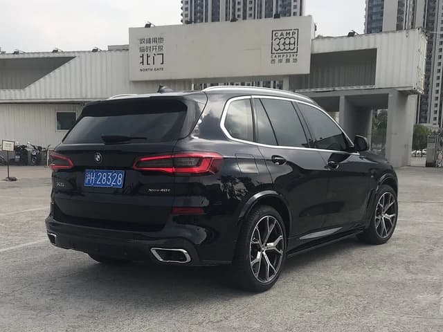 Black BMW X5 (G05) parked outside, seen from the rear three-quarter angle.