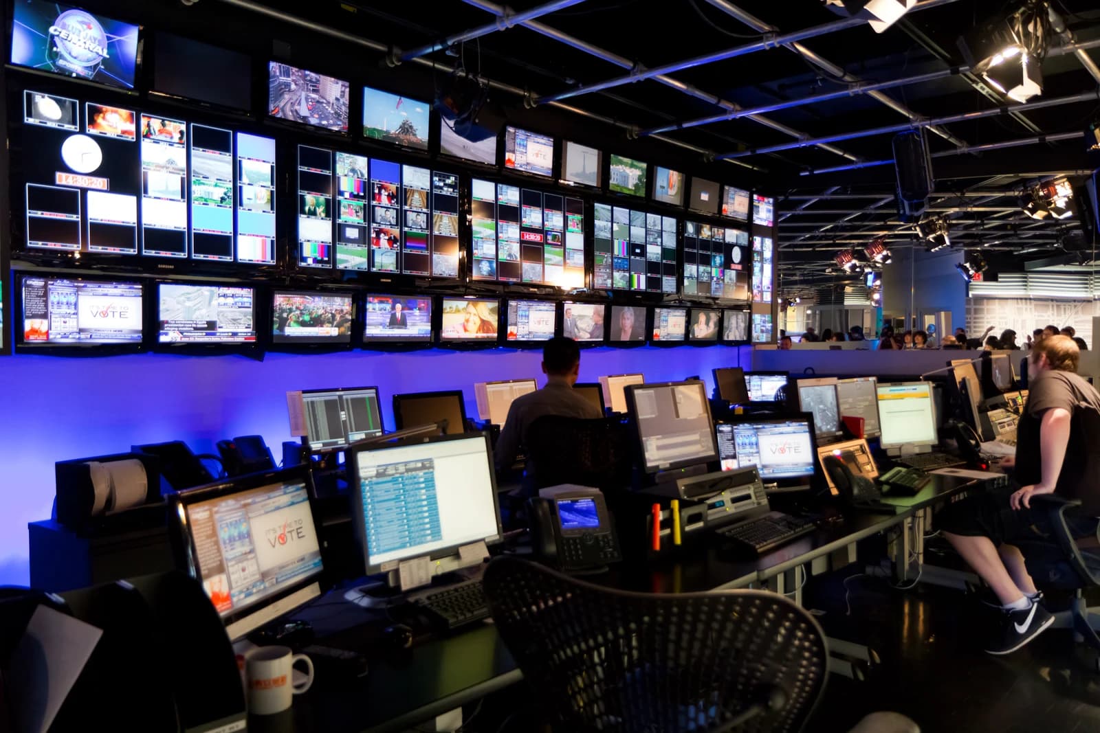 Television control room with multiple monitors displaying various live feeds.