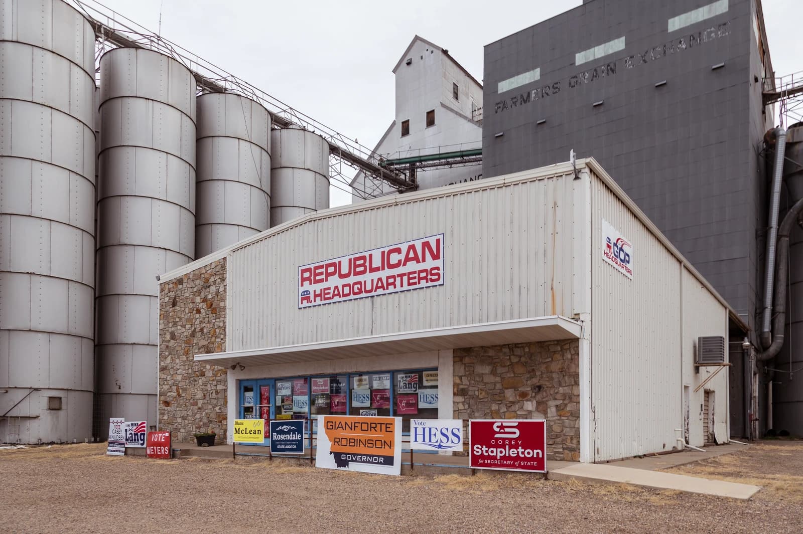 Republican Headquarters building with multiple campaign signs for local candidates and large grain silos.