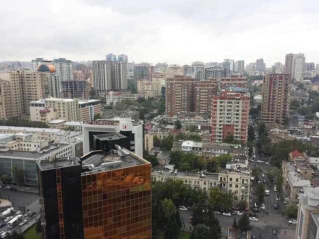 Overview of city buildings in Baku, Azerbaijan under an overcast sky.