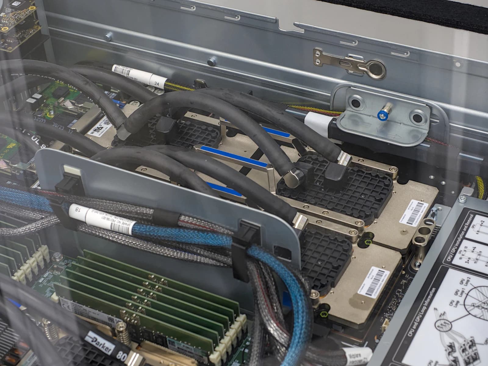 Internal components of a supercomputer, including chips, cooling hoses, and memory modules.
