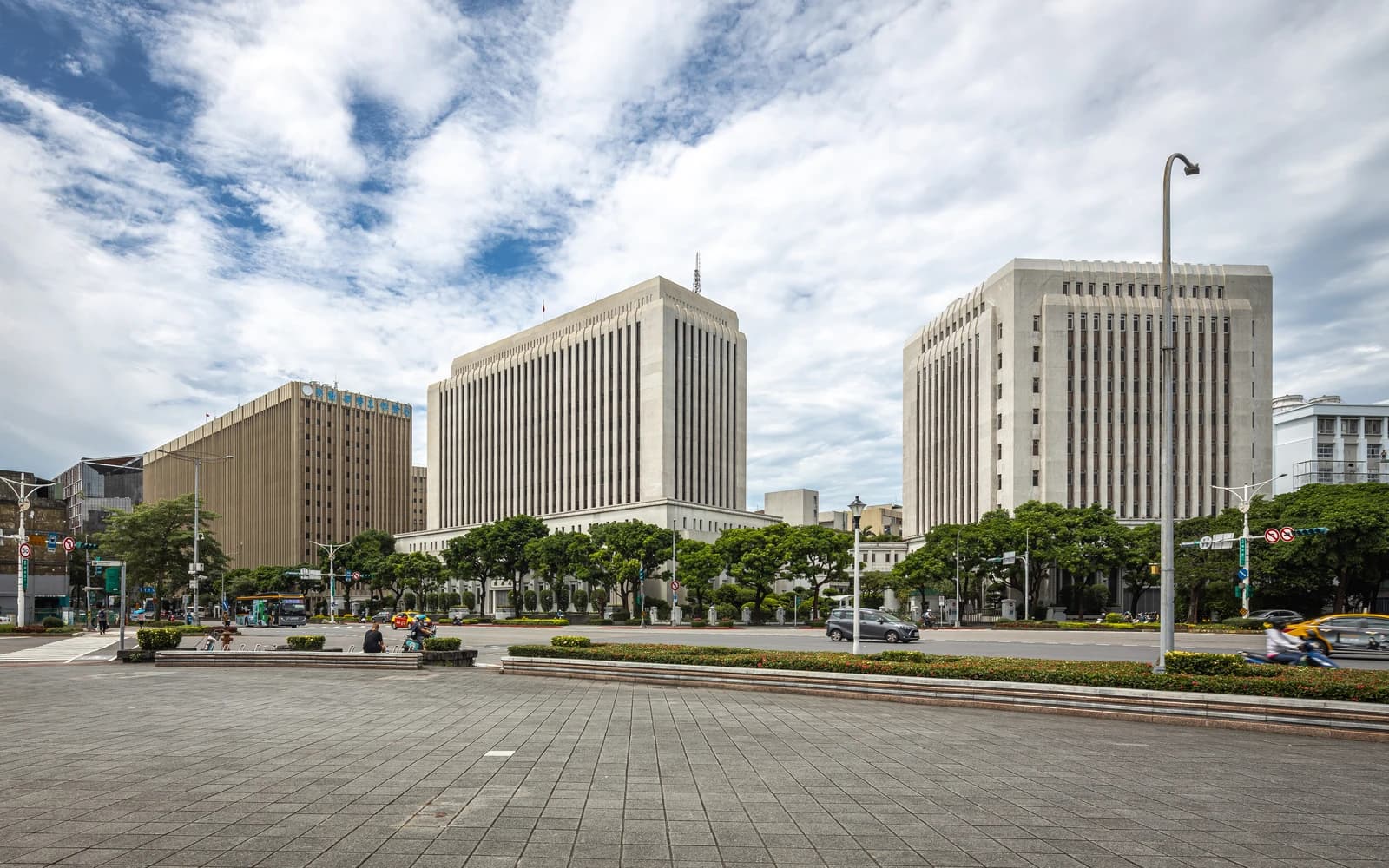 Central Bank of the Republic of China and Bureau of Labor Insurance buildings under a cloudy sky.