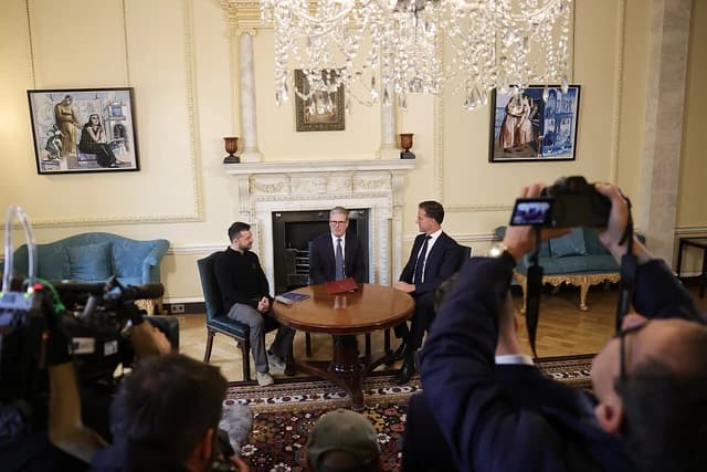 Ukrainian President Volodymyr Zelenskyy, British Prime Minister Keir Starmer, and NATO Secretary General Mark Rutte sit around a table.
