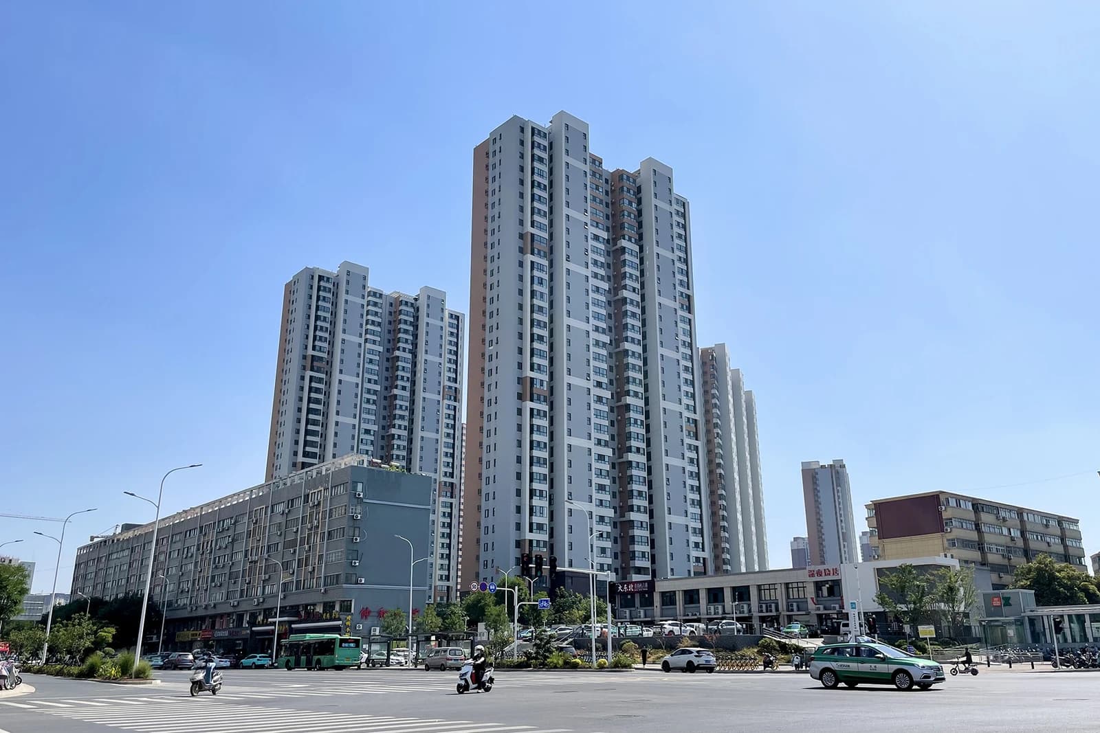 High-rise residential buildings and street intersection in Wangzhai Settlement Area under clear sky.