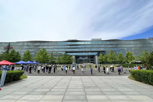 People queuing outside the modern Baidu headquarters building in Beijing.