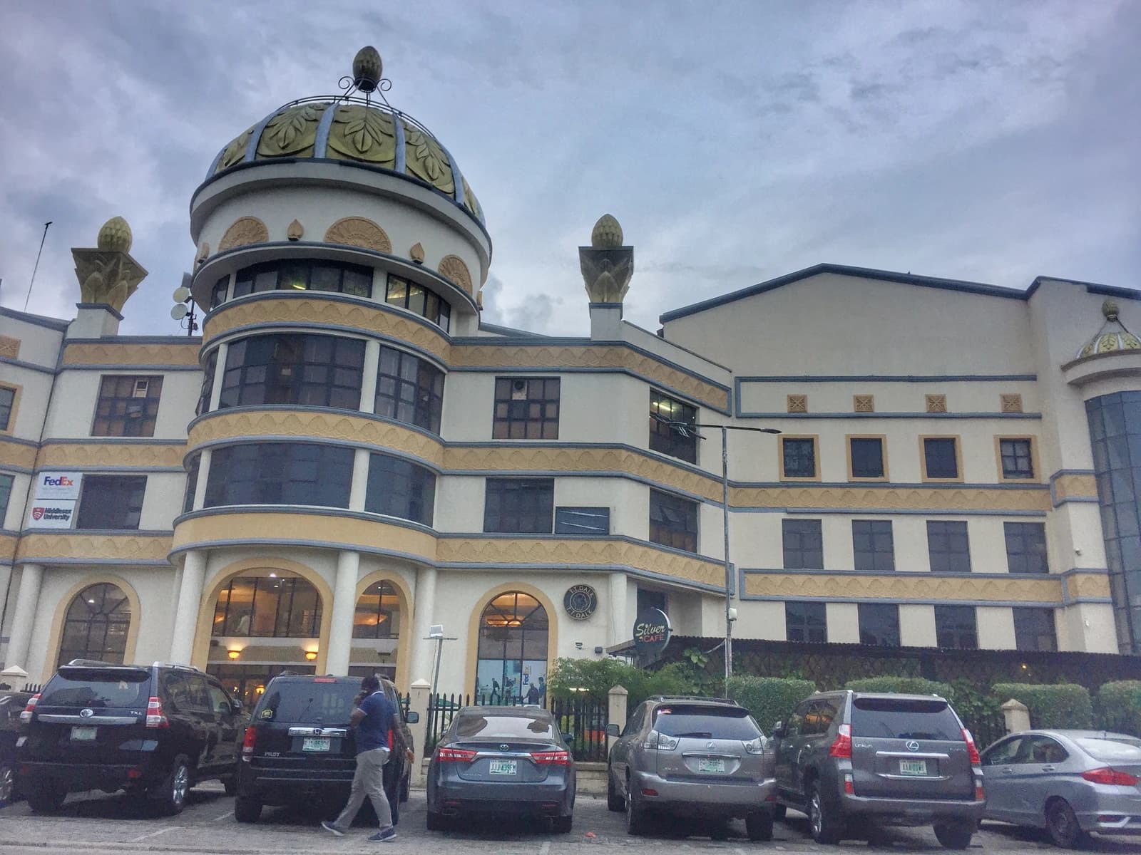 Exterior of Silverbird Cinema building with cars parked in front in Lagos.